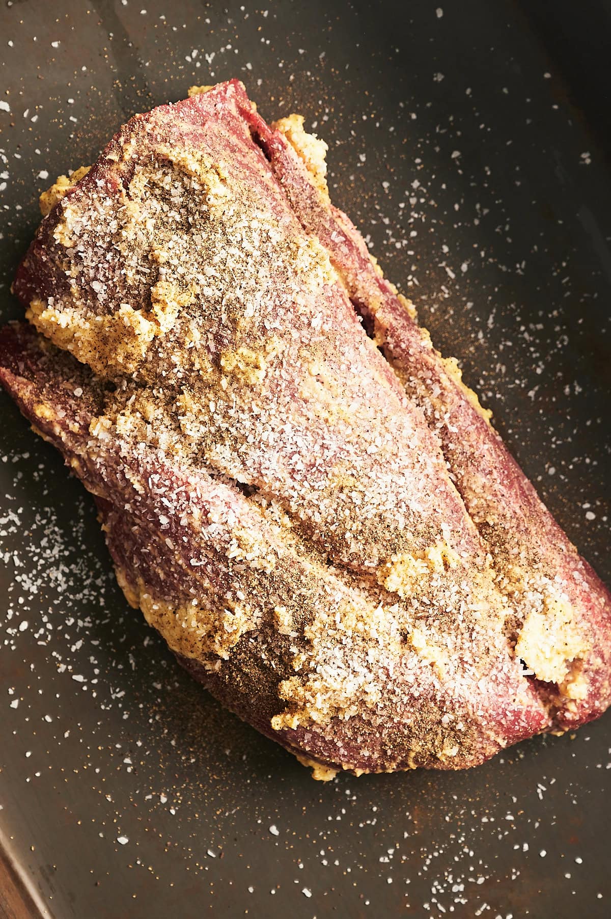 whole beef tenderloin coated with butter, mustard, salt and pepper.