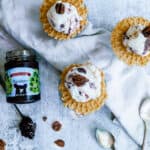 three bowls of blackberry whiskey ice cream on pizzelle cookies with Crofter's jam