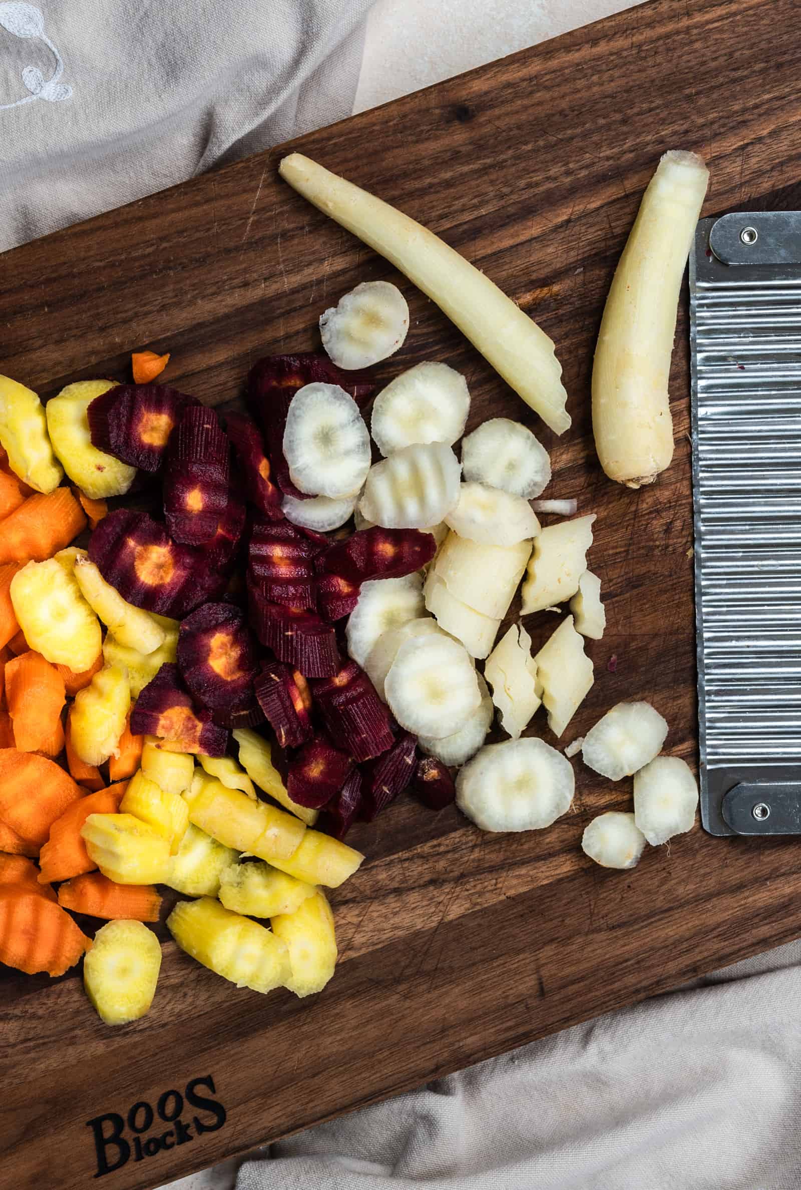 chopped carrots on a brown cutting board.
