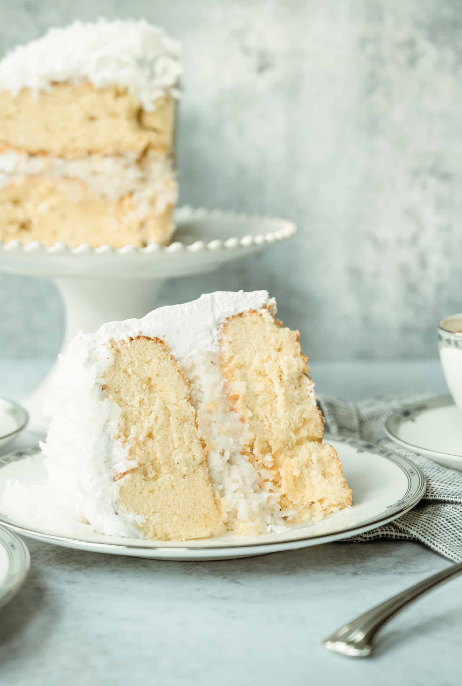 pieces of coconut cake on a plate and small cake plate