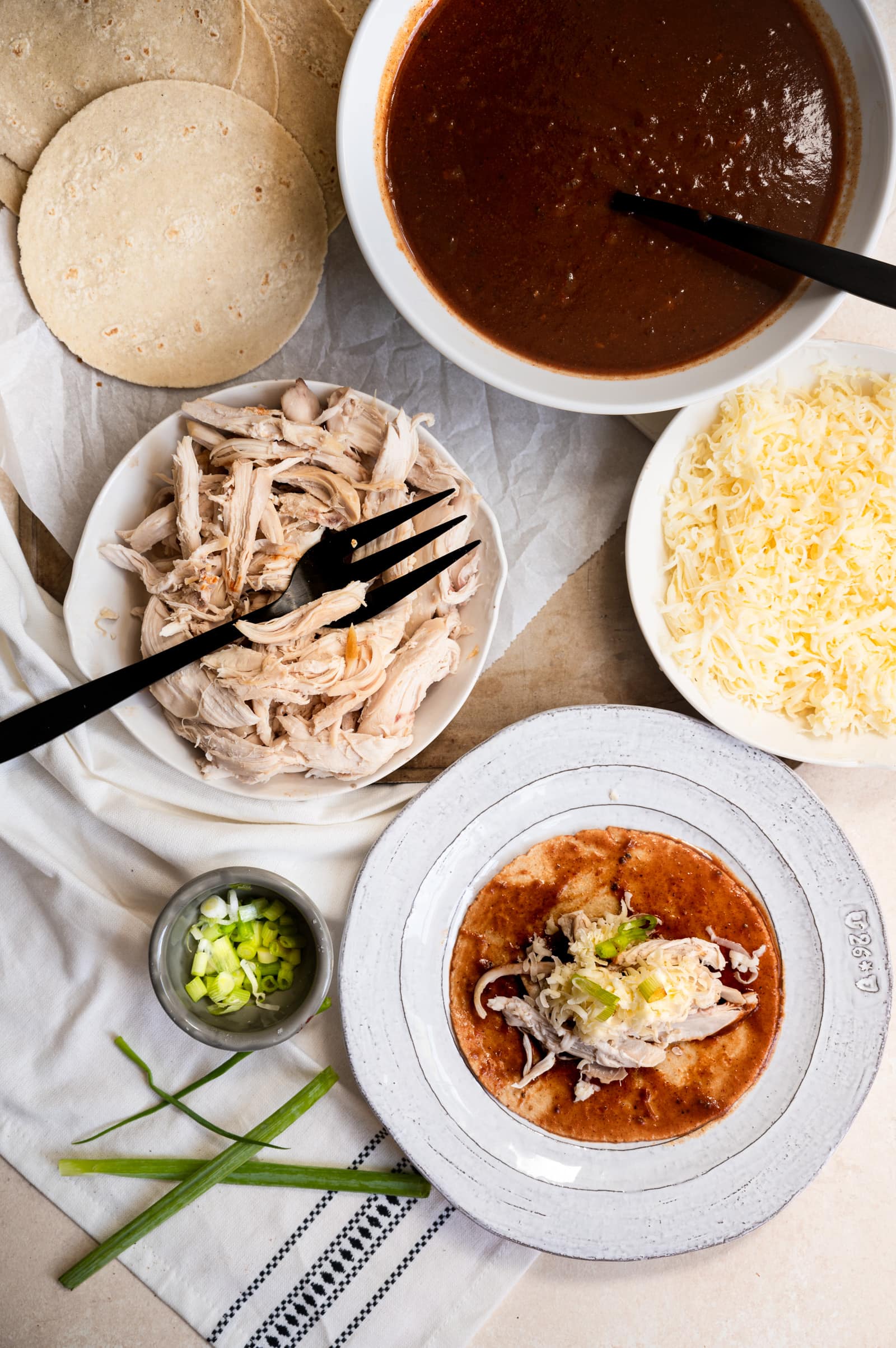 steps for rolling enchiladas topping with cheese