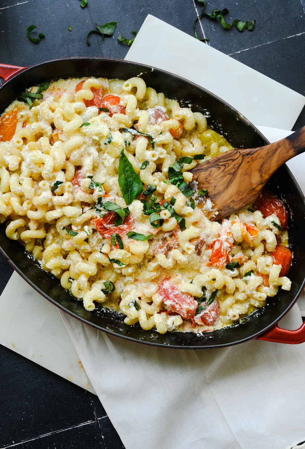 baked goat cheese pasta sauce being stirred.