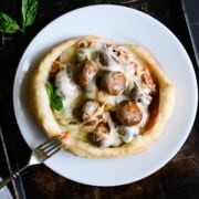 pizza with whole mushrooms and cheese on a white plate.