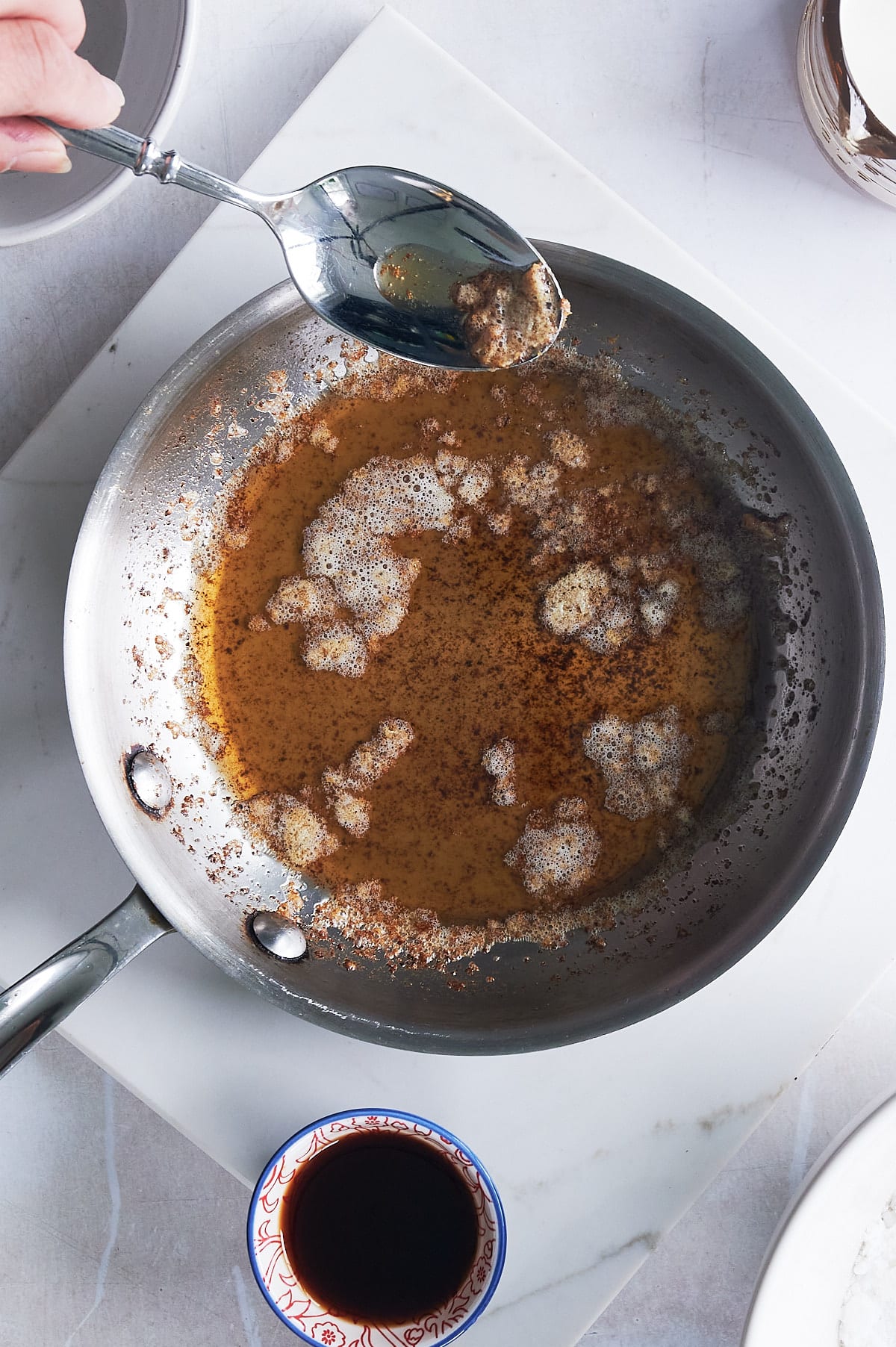 skilled of browned butter with butter solids being skimmed off