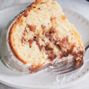 Close up of baked apple cinnamon bundt cake with white glaze