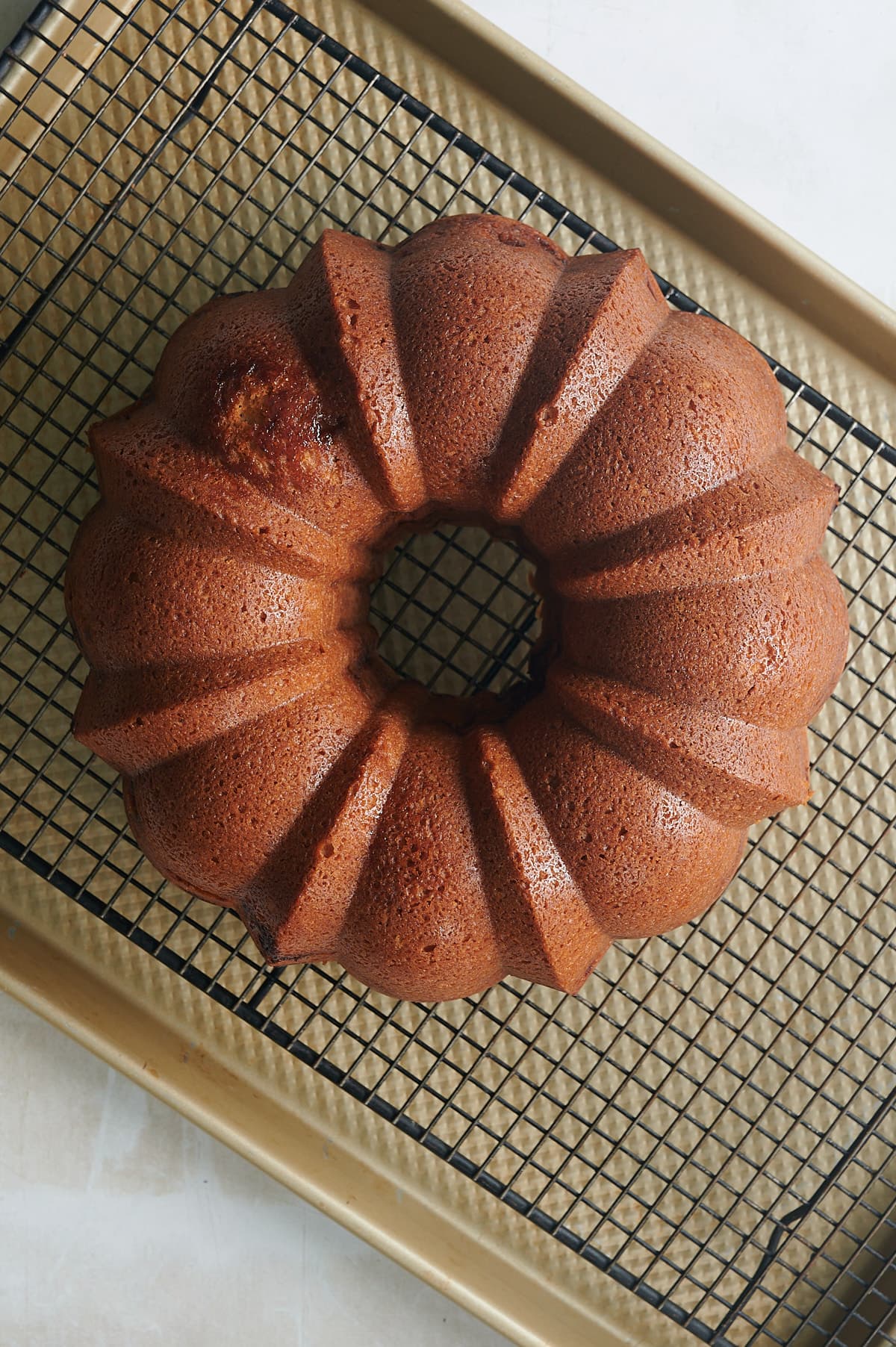 Second finished apple bundt cake on a black cooling rack