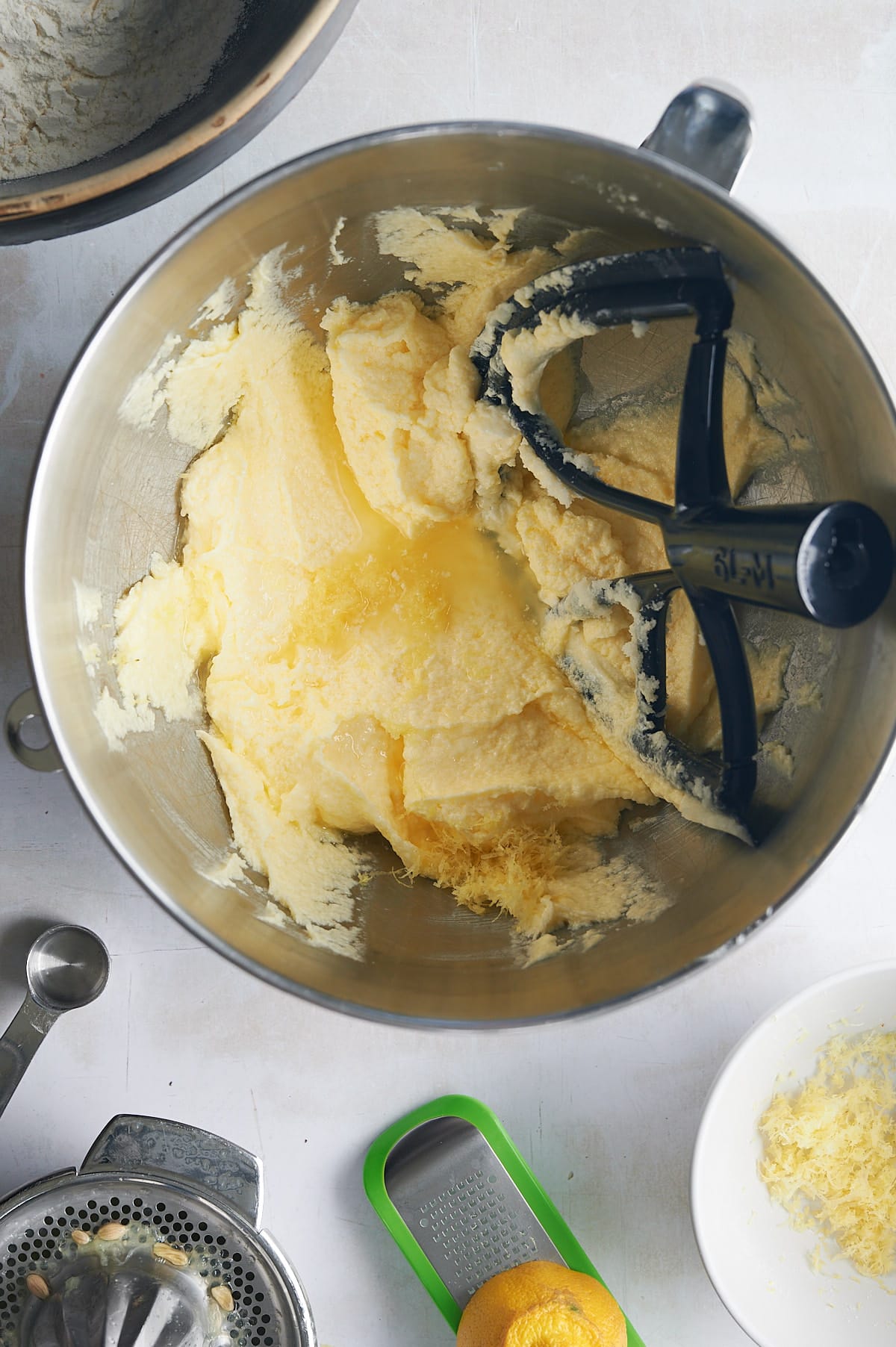creamed sugar, butter for lemon knot cookies with lemon zest in mixing bowl