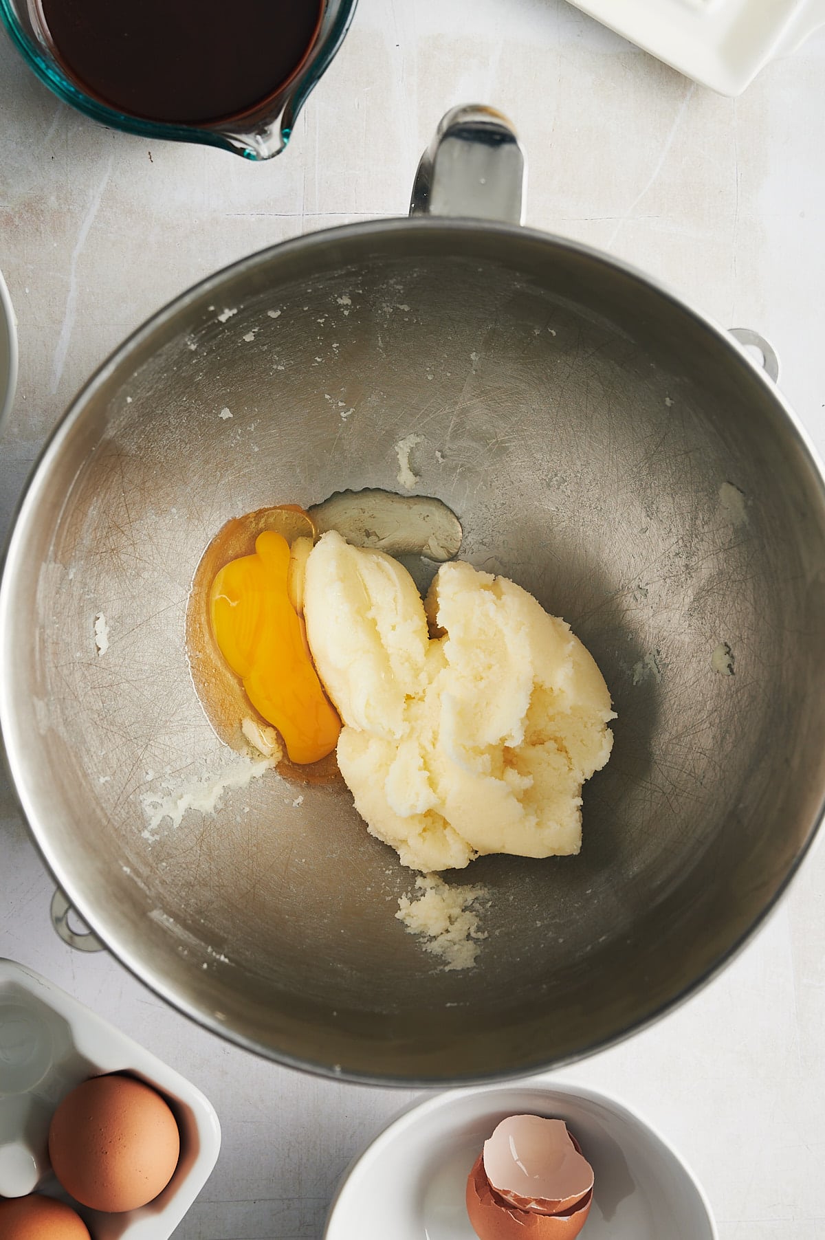 eggs being mixed into confectioners sugar and butter for brownies.