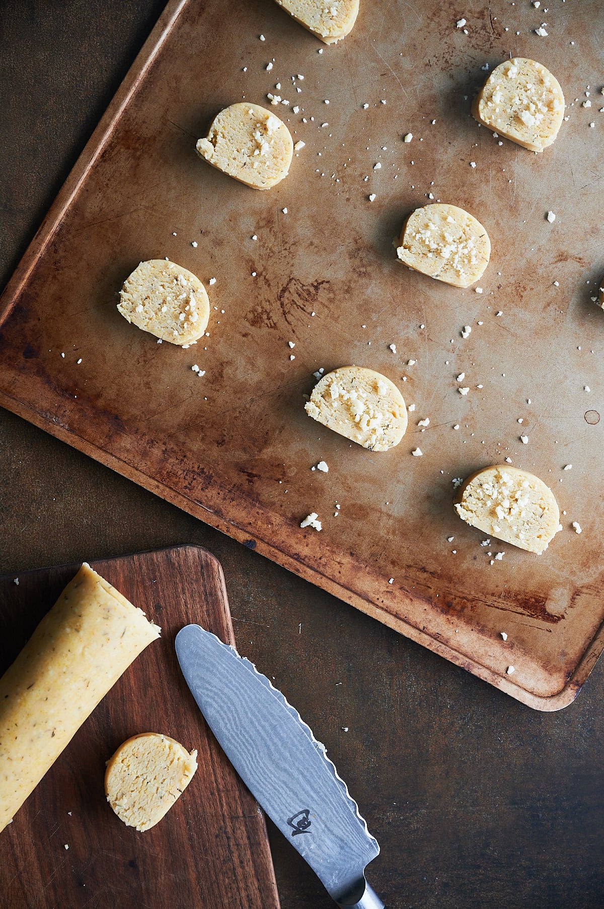 sheet pan of unbaked parmesan thyme crackers sprinkled with parmesan.