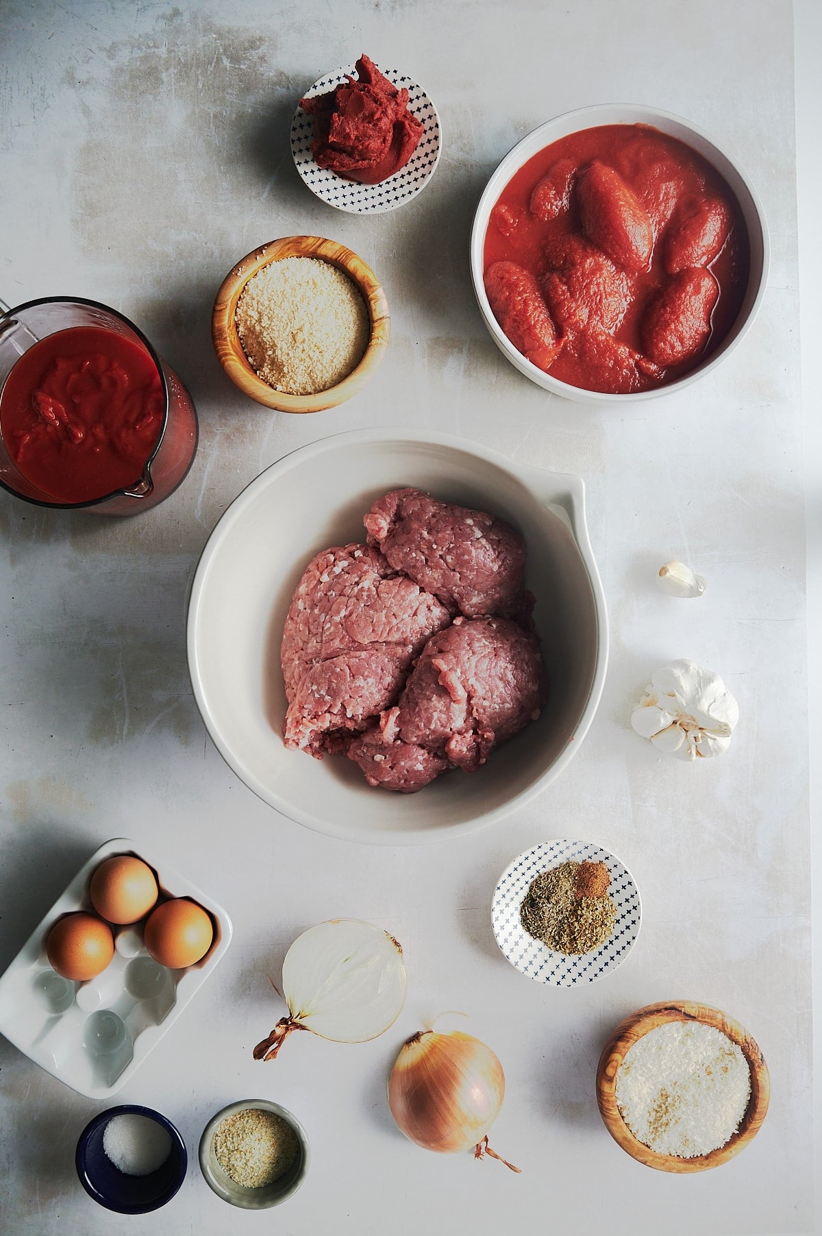 ingredients for ground chicken meatballs and tomato sauce.