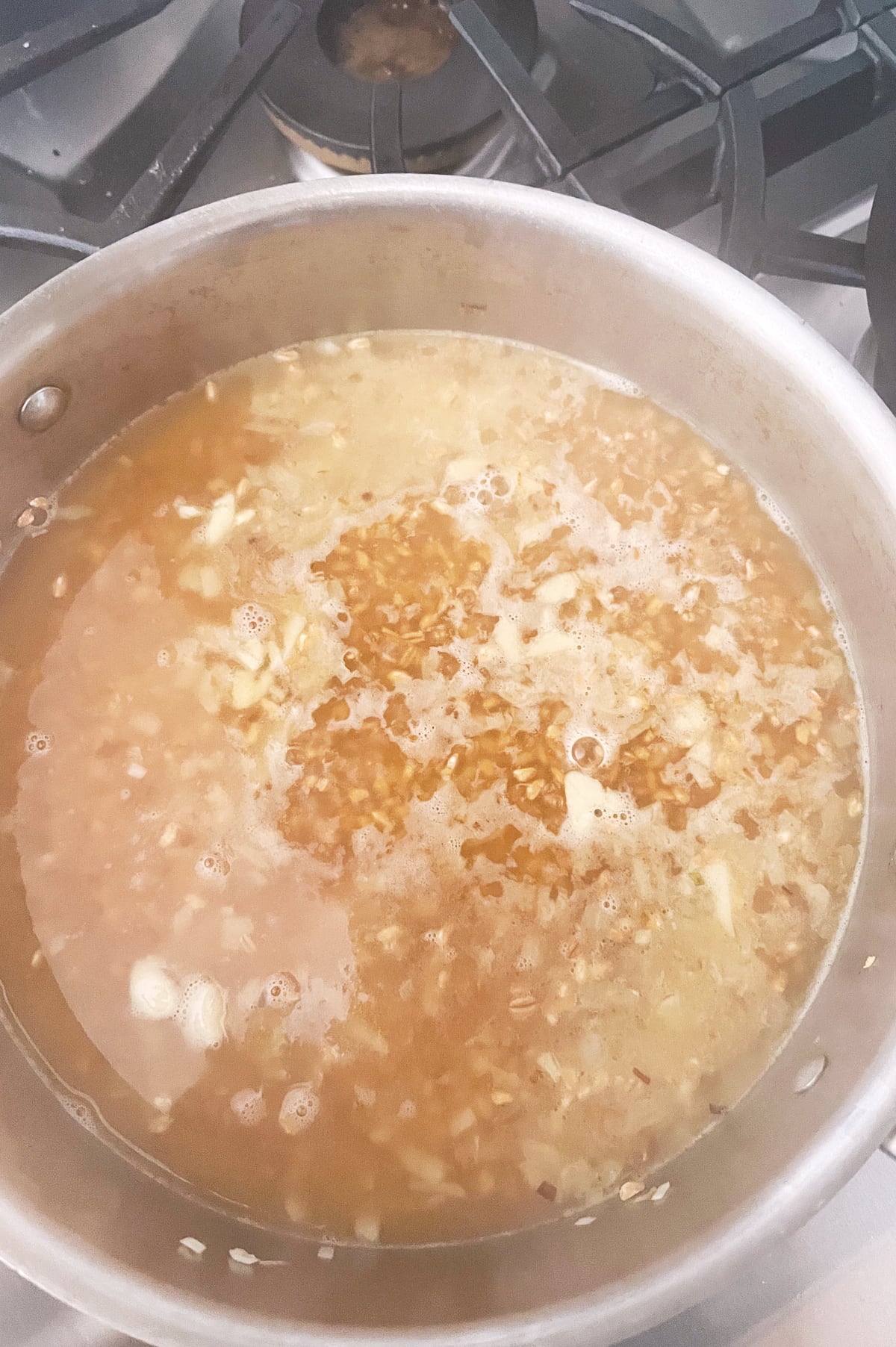 simmering chicken stock cooking farro risotto