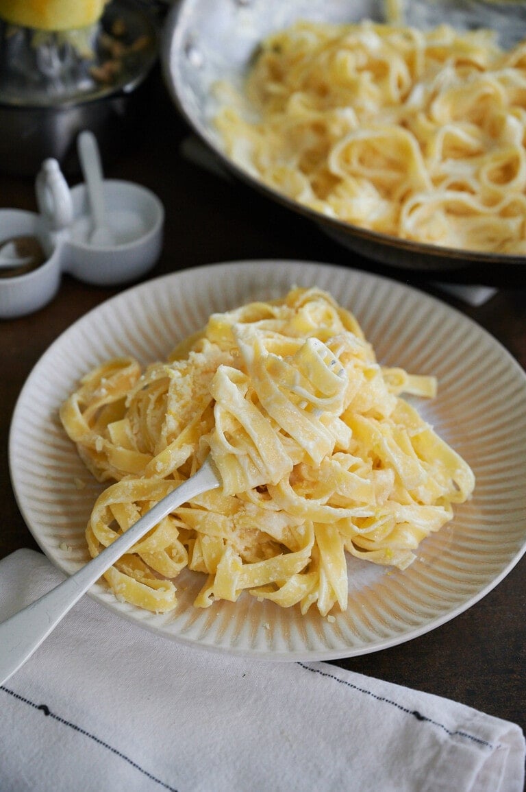 a fork twirling tagliatelle in lemon sauce
