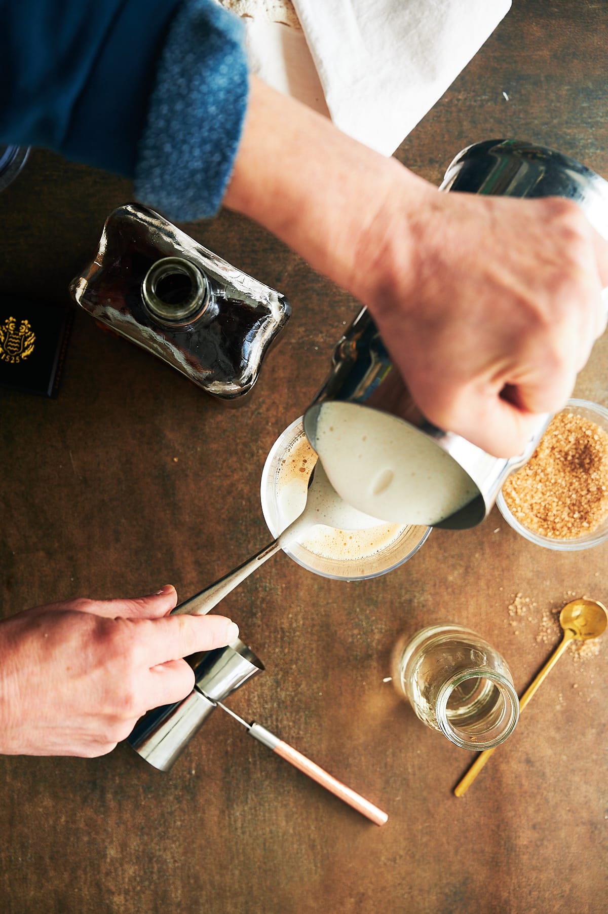 frother milk being poured into amaretto coffee.