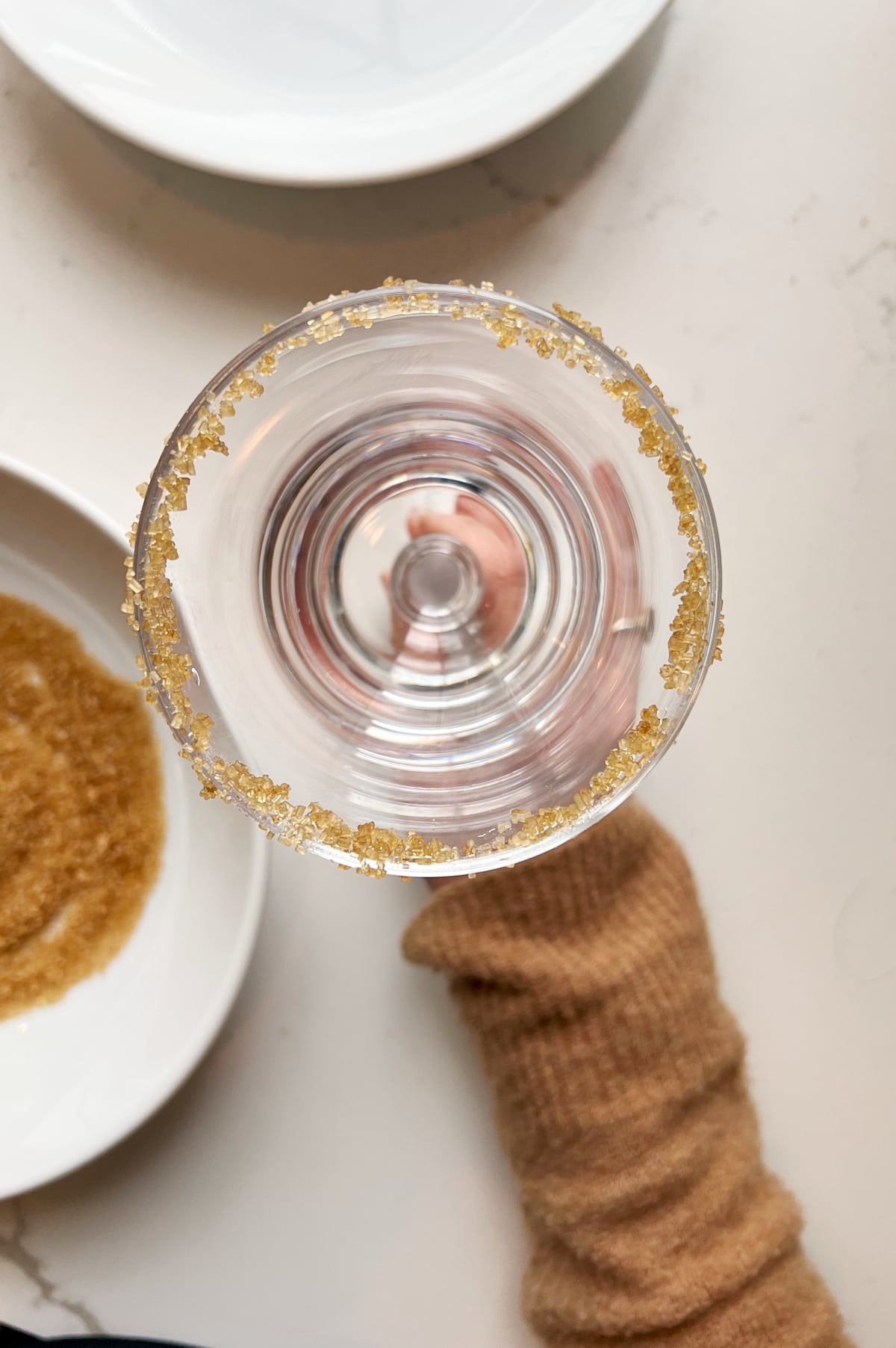 hand holding sugar rimmed glass for amaretto coffee.