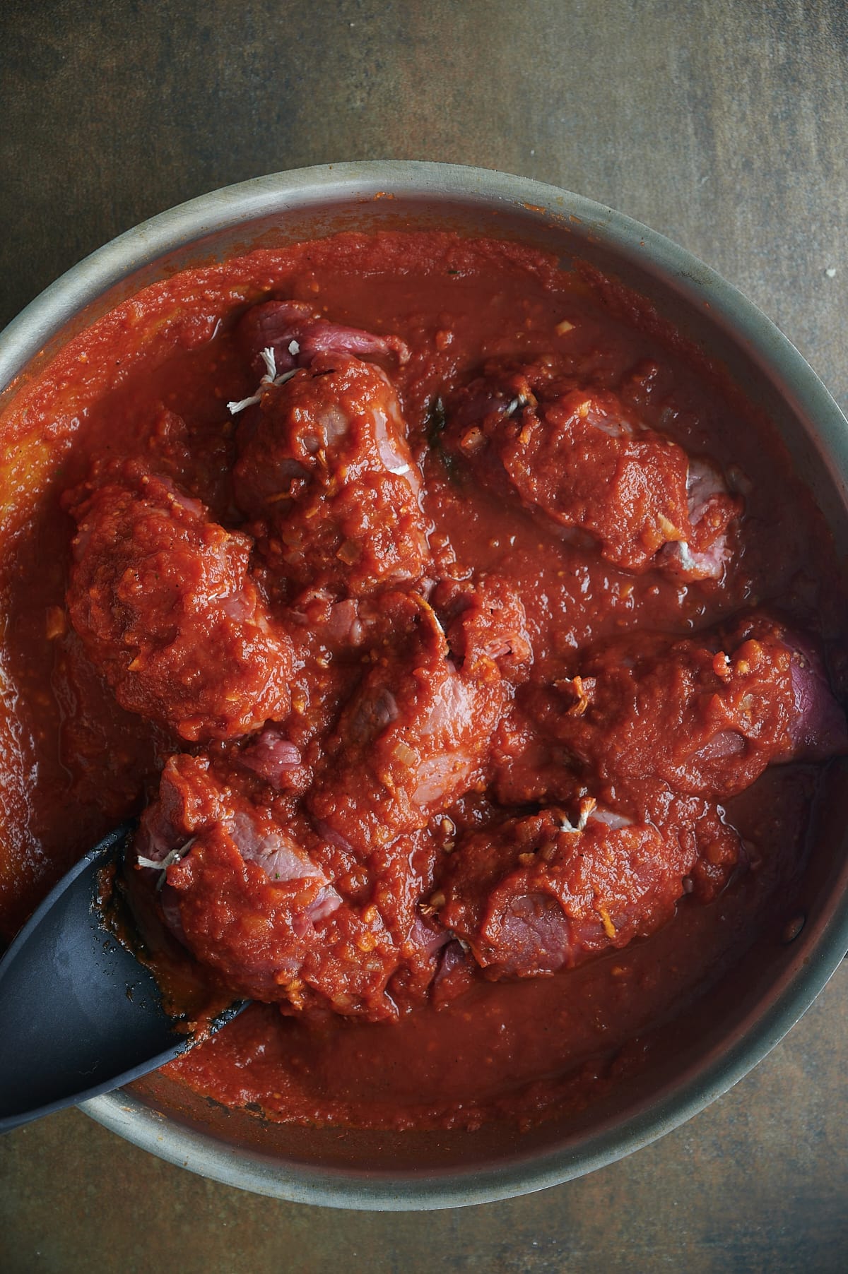Braciole rolls simmer in tomato sauce.