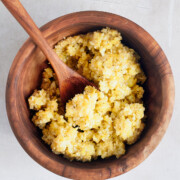 wooden bowl of lemon pesto with wooden spoon.