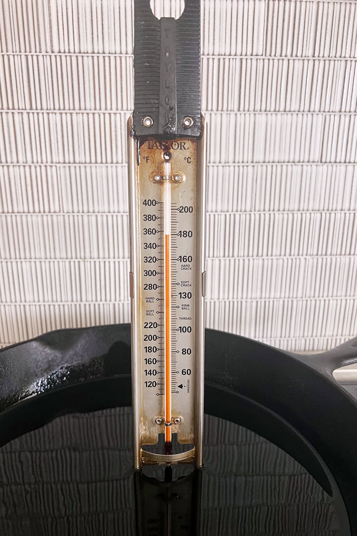 Thermometer reaching 350˚ in oil for frying chicken cutlets