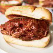 Finished caraway red beef sandwich on toasted roll and white plate