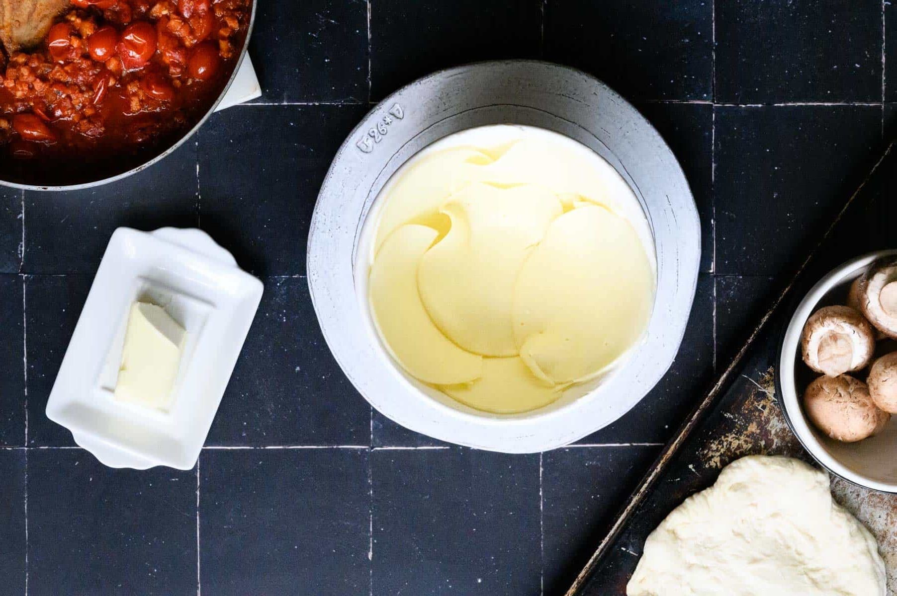 provolone lining inside of a white bowl.