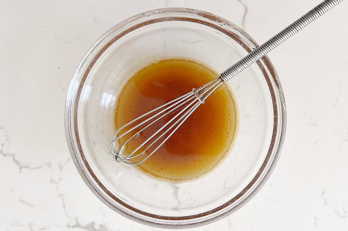 clear bowl of molasses, vanilla, and maple syrup mixed together.