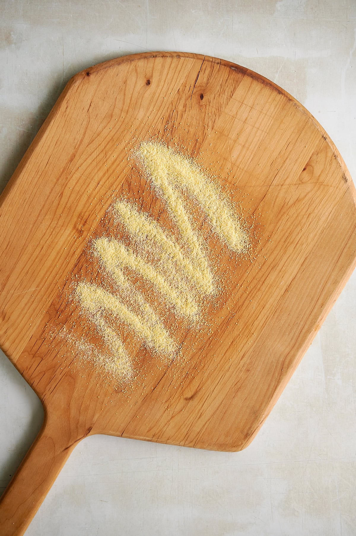 Cornmeal sprinkled on board for calzone.