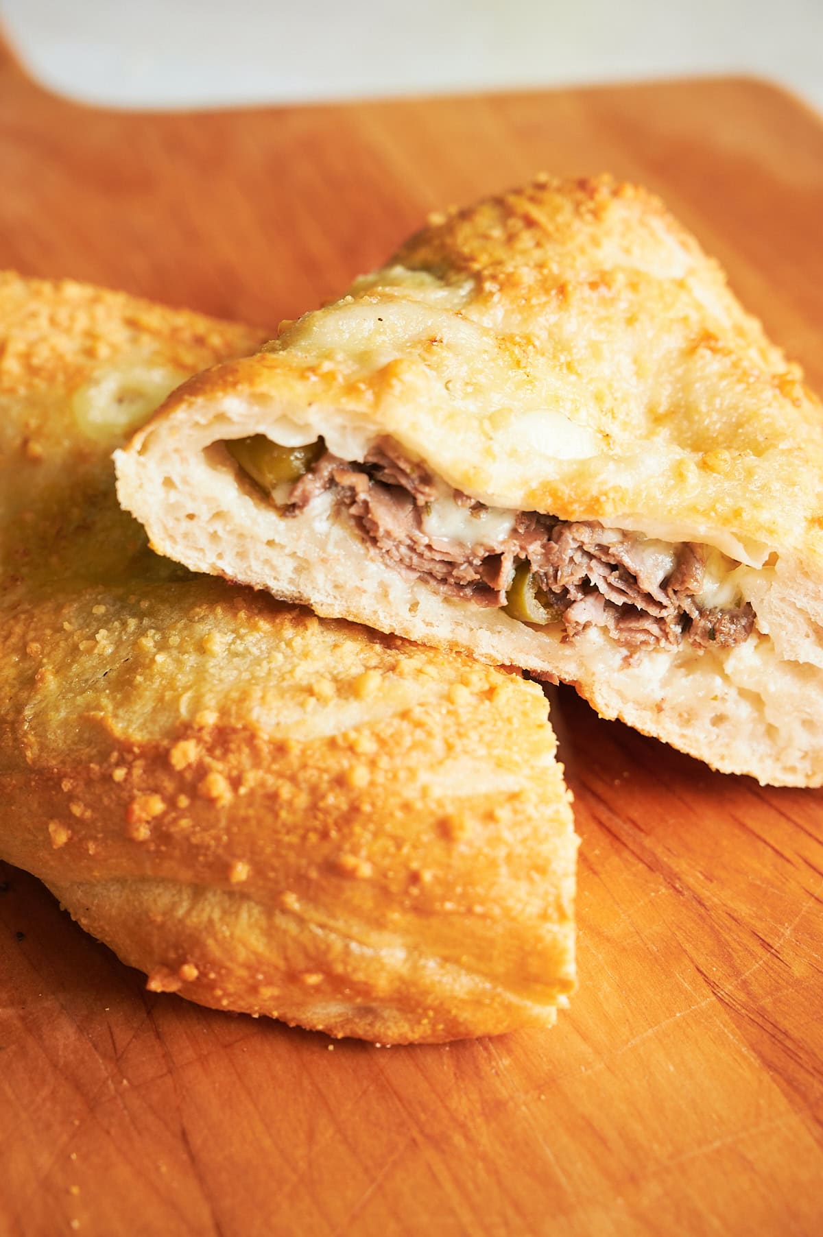 close up of halves of Italian beef calzone.