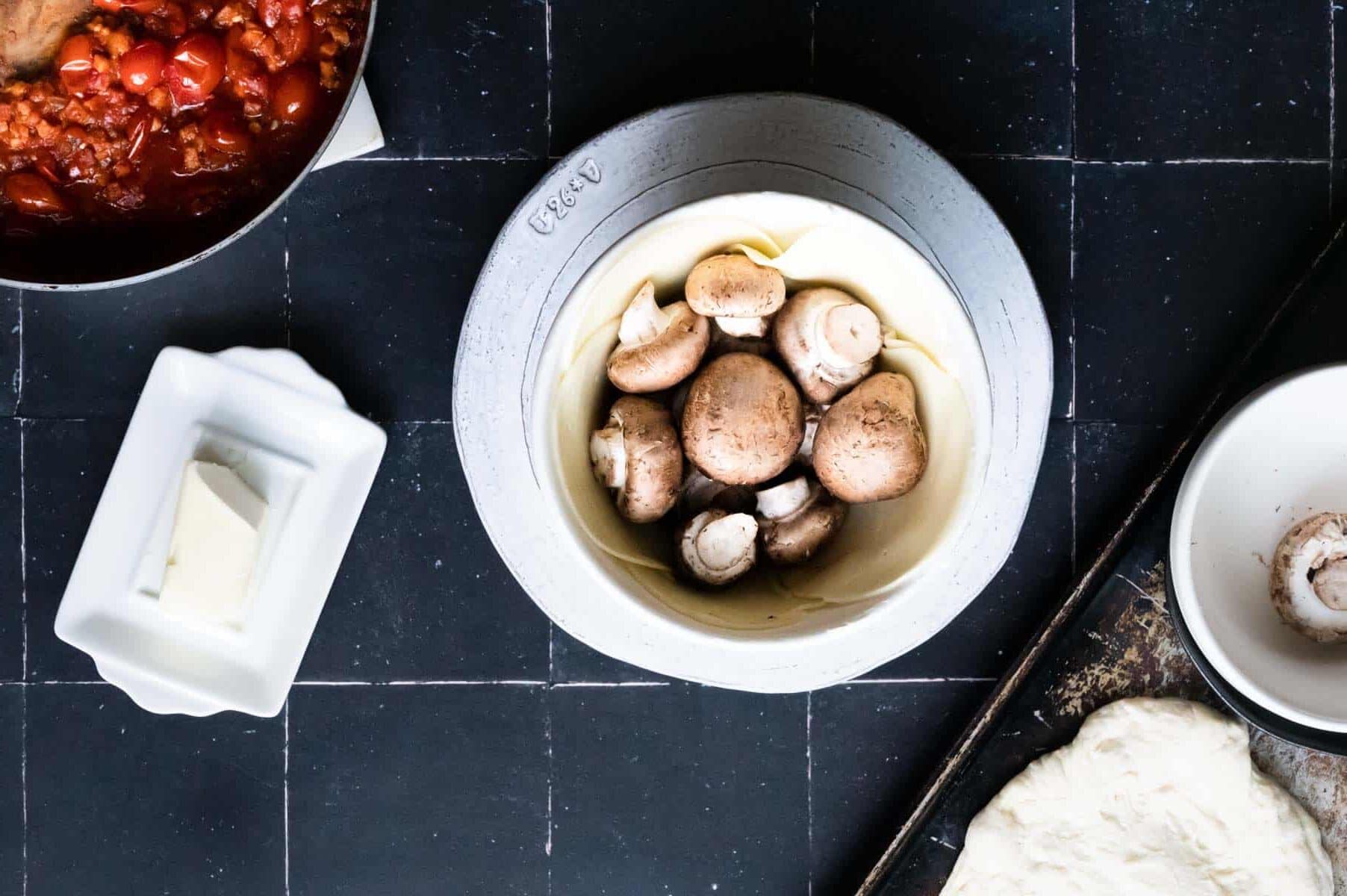 provolone and mushrooms in a white bowl.