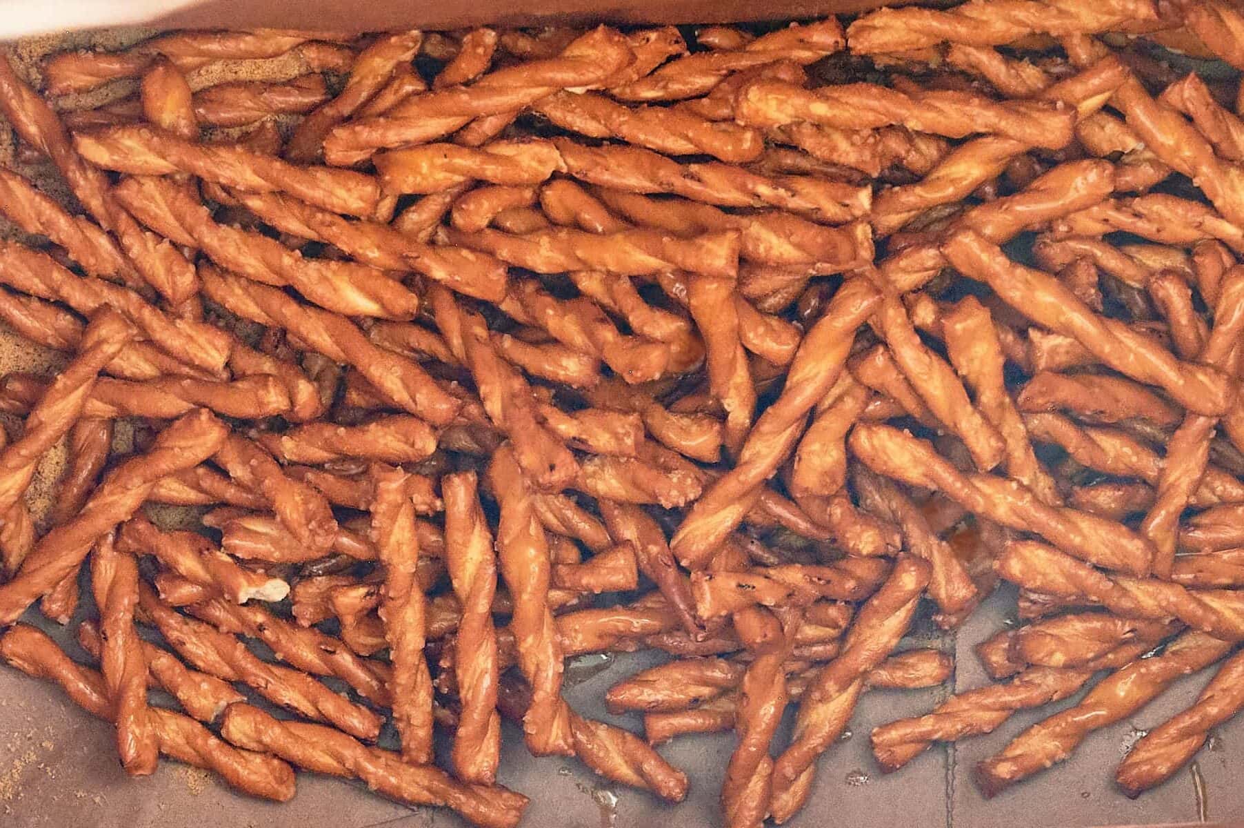 Oil added to brown bag with butter braid pretzels.