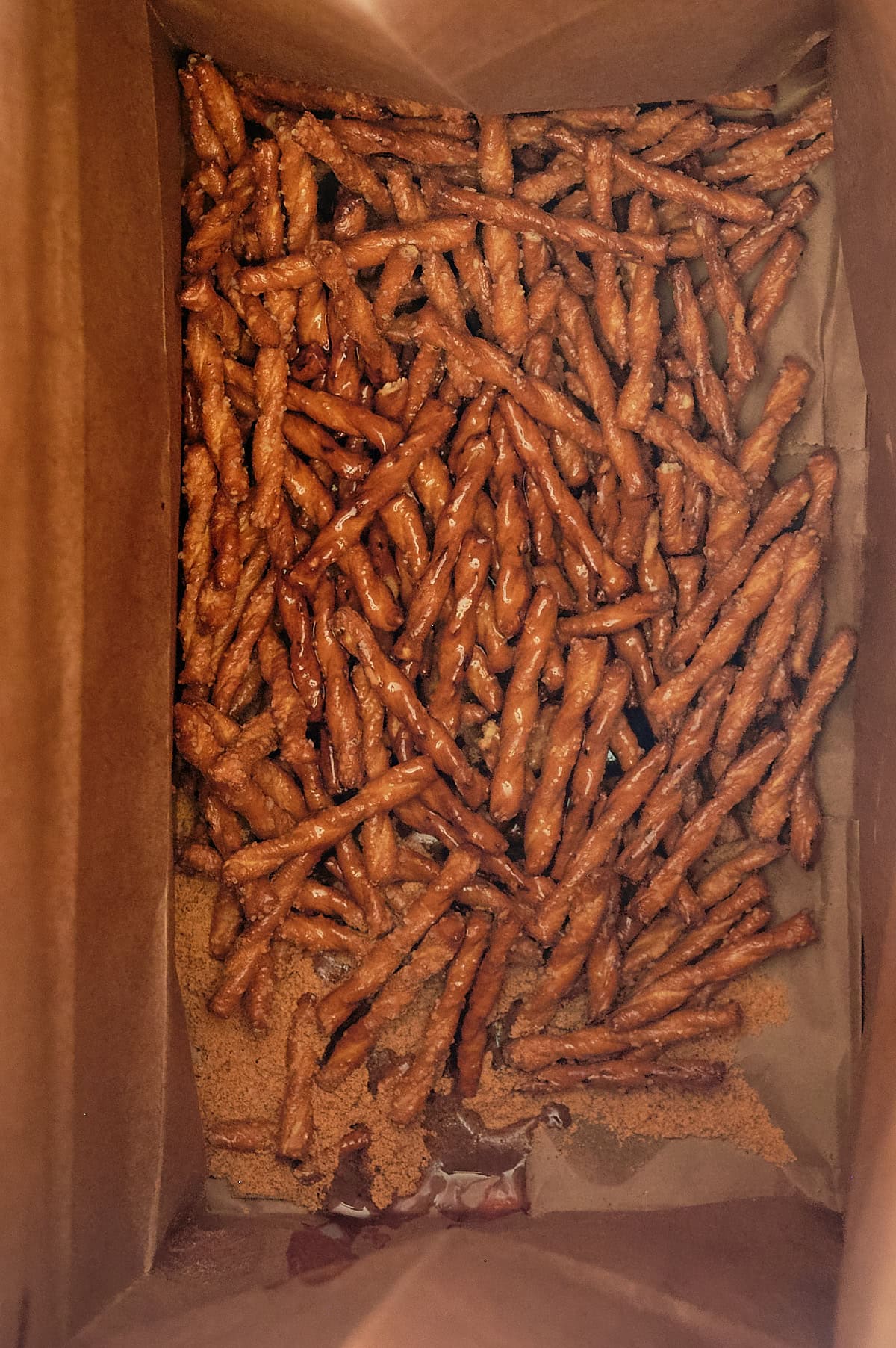 brown paper bag with oil and southwest seasoning on pretzels