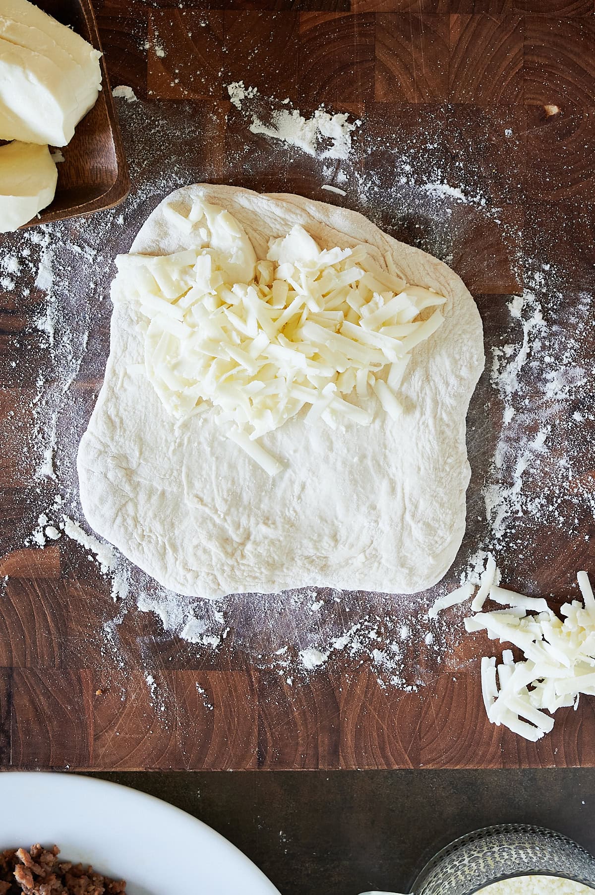 calzone dough topped with fresh mozzarella and sprinkled with grated fontinella cheese.