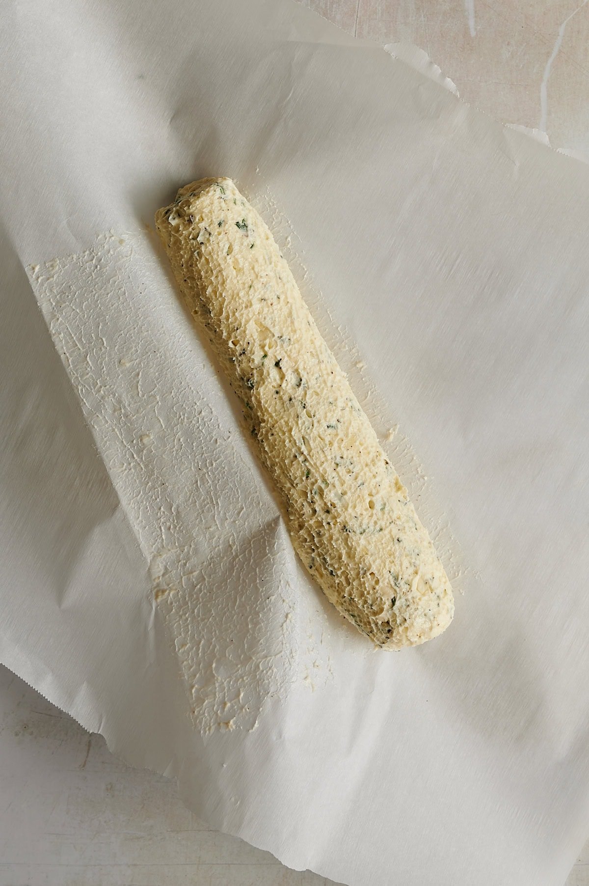 log of rolled compound butter on a piece of parchment paper.