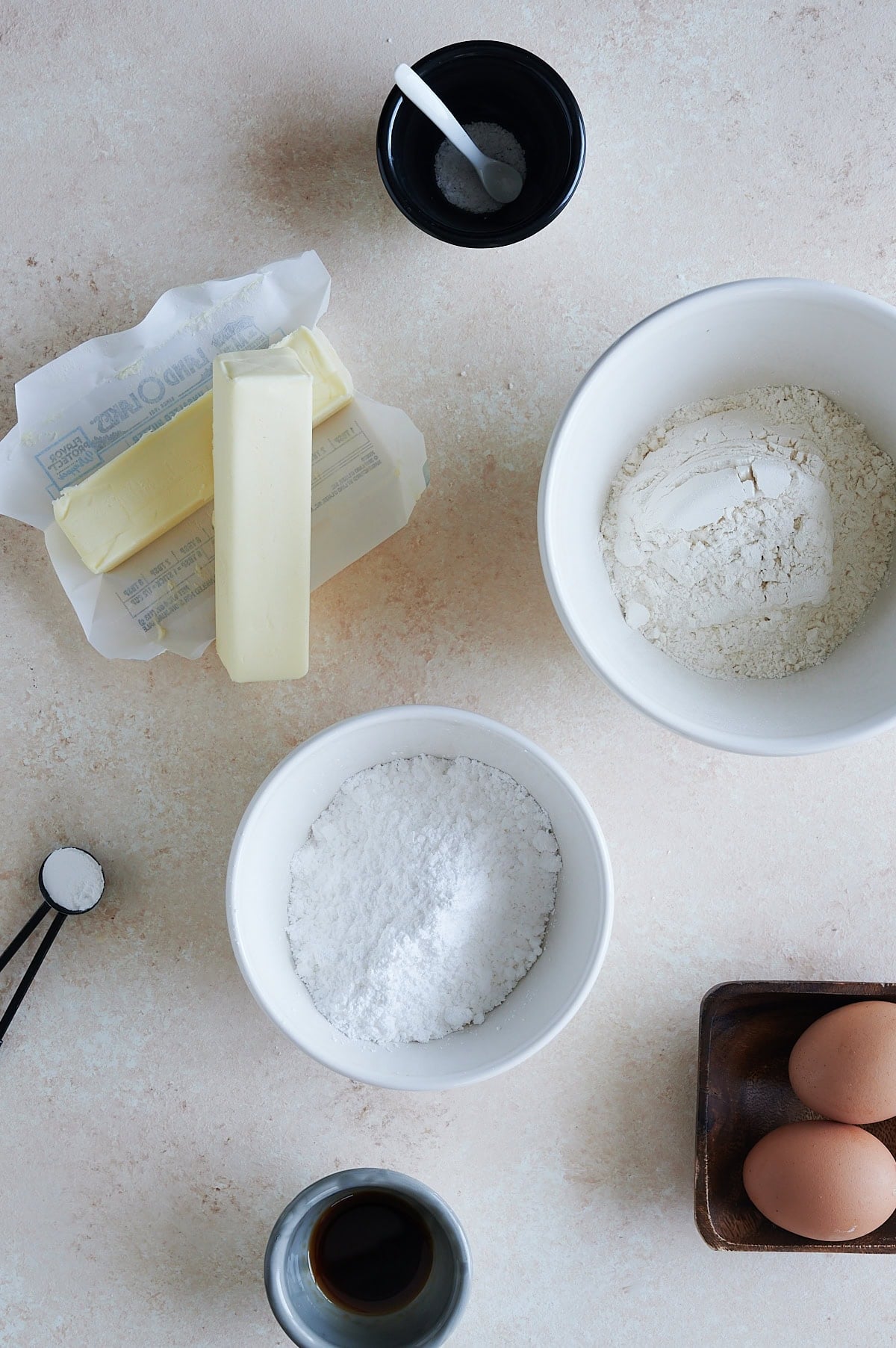 Ingredients for Italian butter cookies on a cream background.