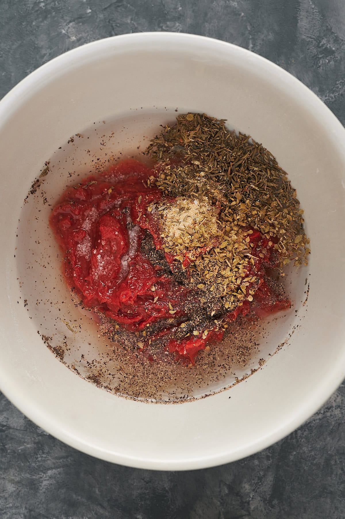 Water added to tomato paste and seasoning for pizza sauce.