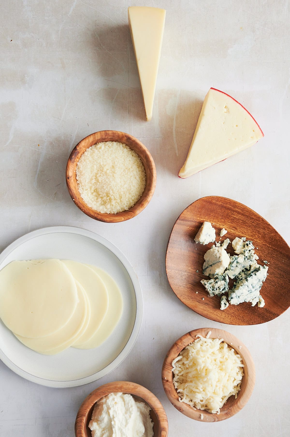 Gruyere, fontina, blue, parmesan, ricotta, provolone and mozzarella cheeses on a white background for pizza.