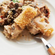 White plate of baked and crispy breadcrumb rigatoni with creamy chicken and mushrooms.