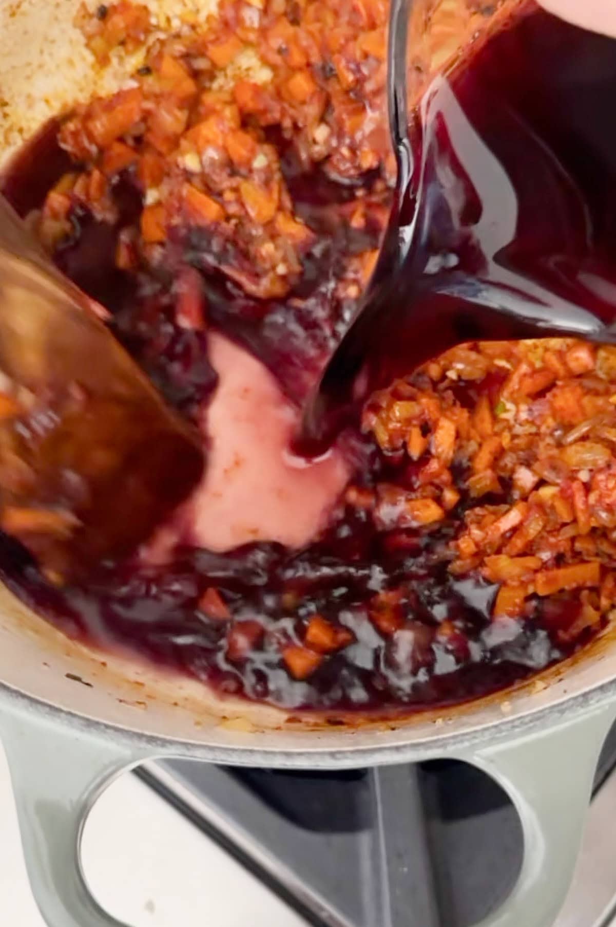 Wine deglazing a braising sauce for beef short ribs.